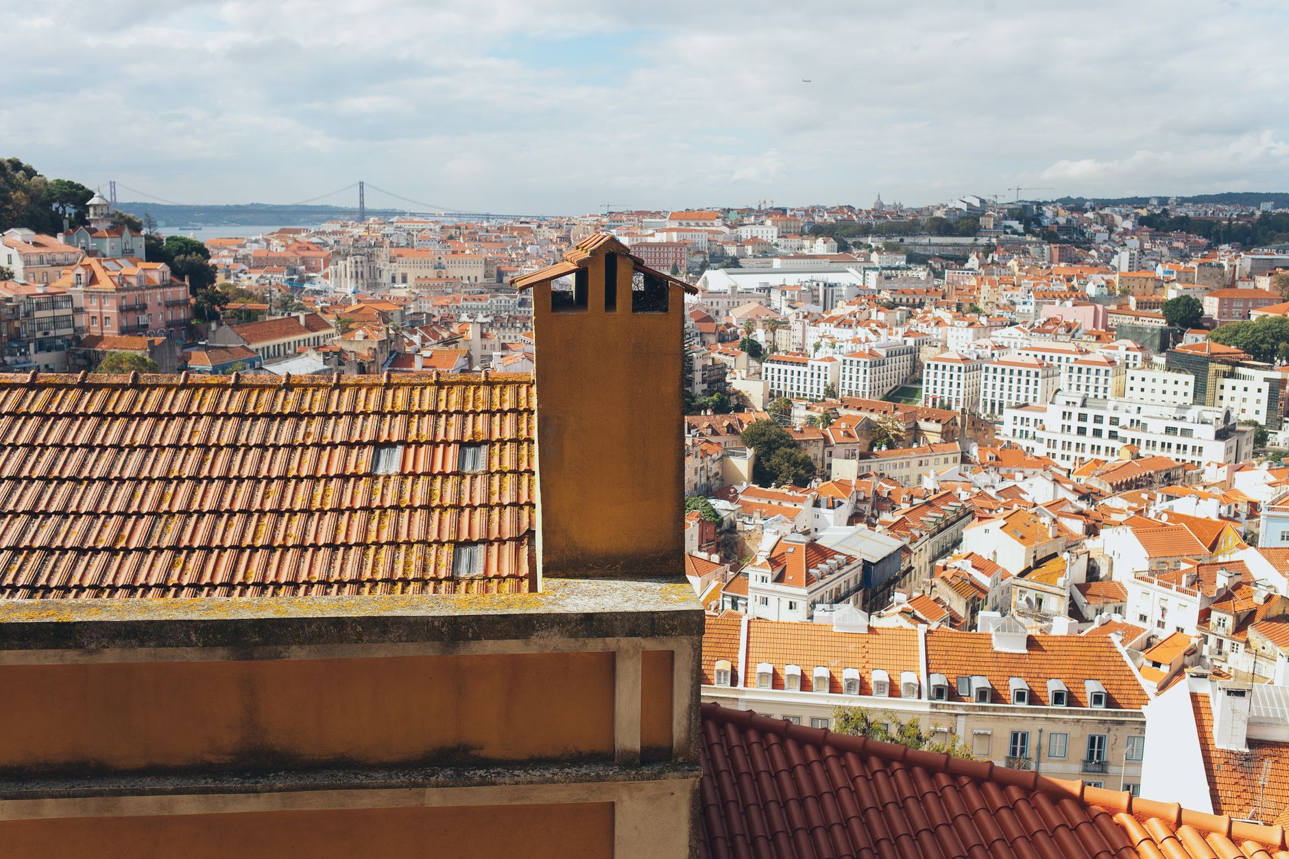 Sunlit terracotta rooftops and tiled facades in Lisbon