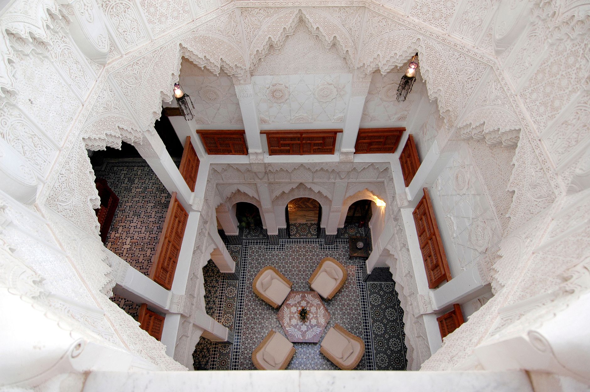 Warm clay walls and arches of a Marrakech courtyard