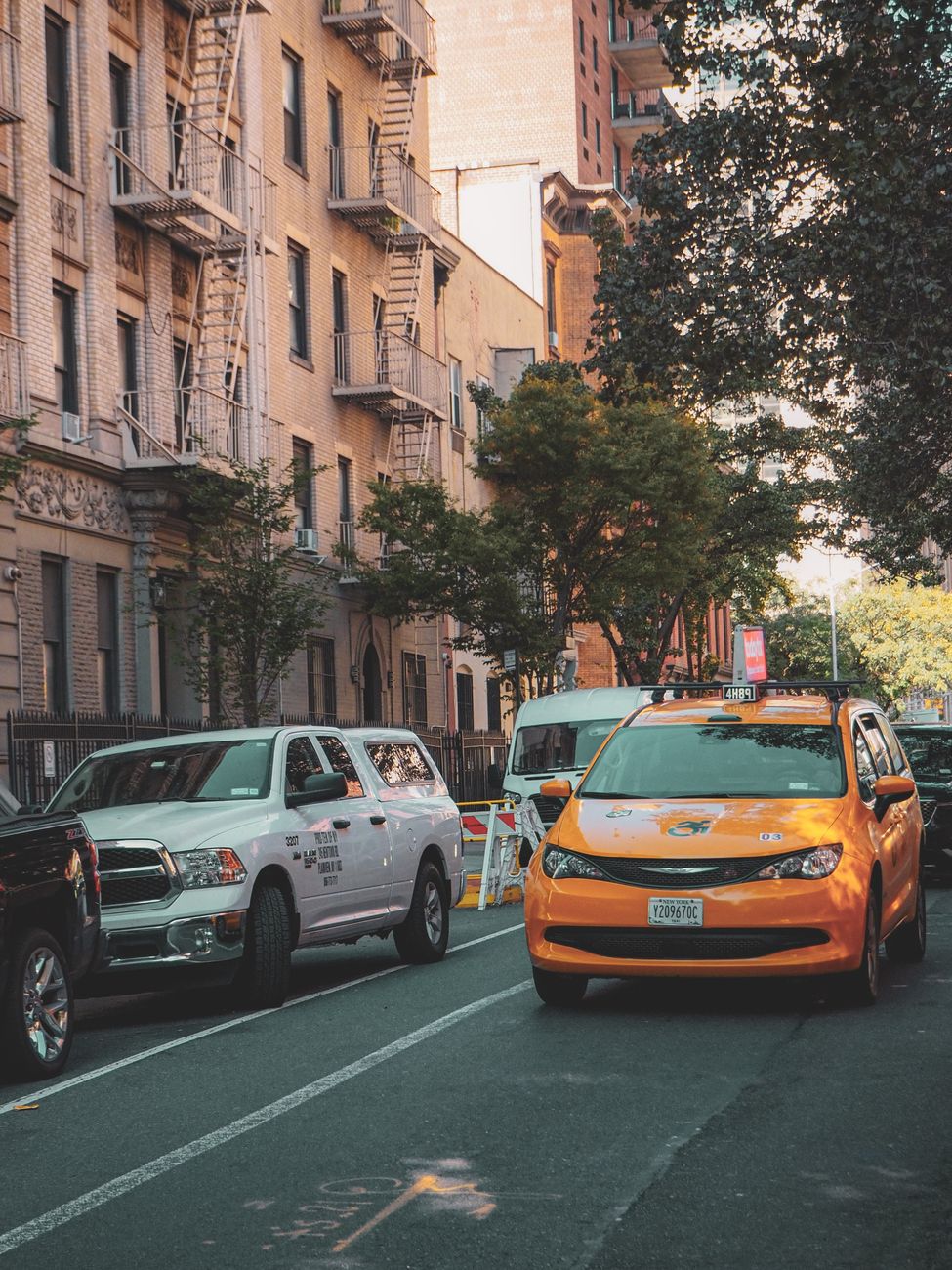 New York avenue framed by tall buildings in morning haze