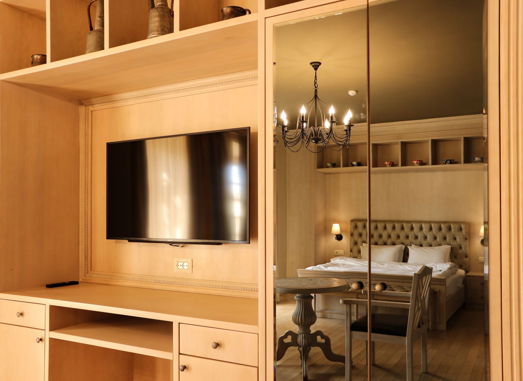An elegant Ubiqub suite with warm lamplight and a large mirror